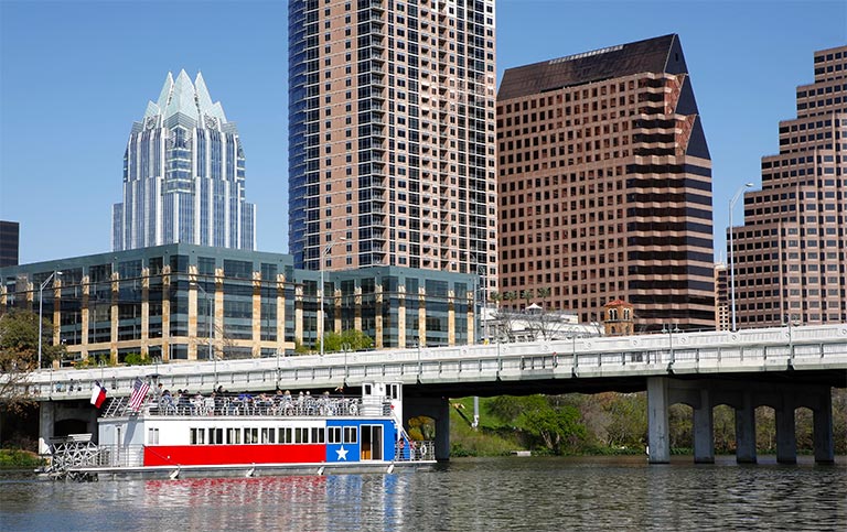 a skyline view of Austin, Texas with a boat