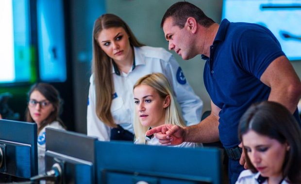 security guards working in surveillance room