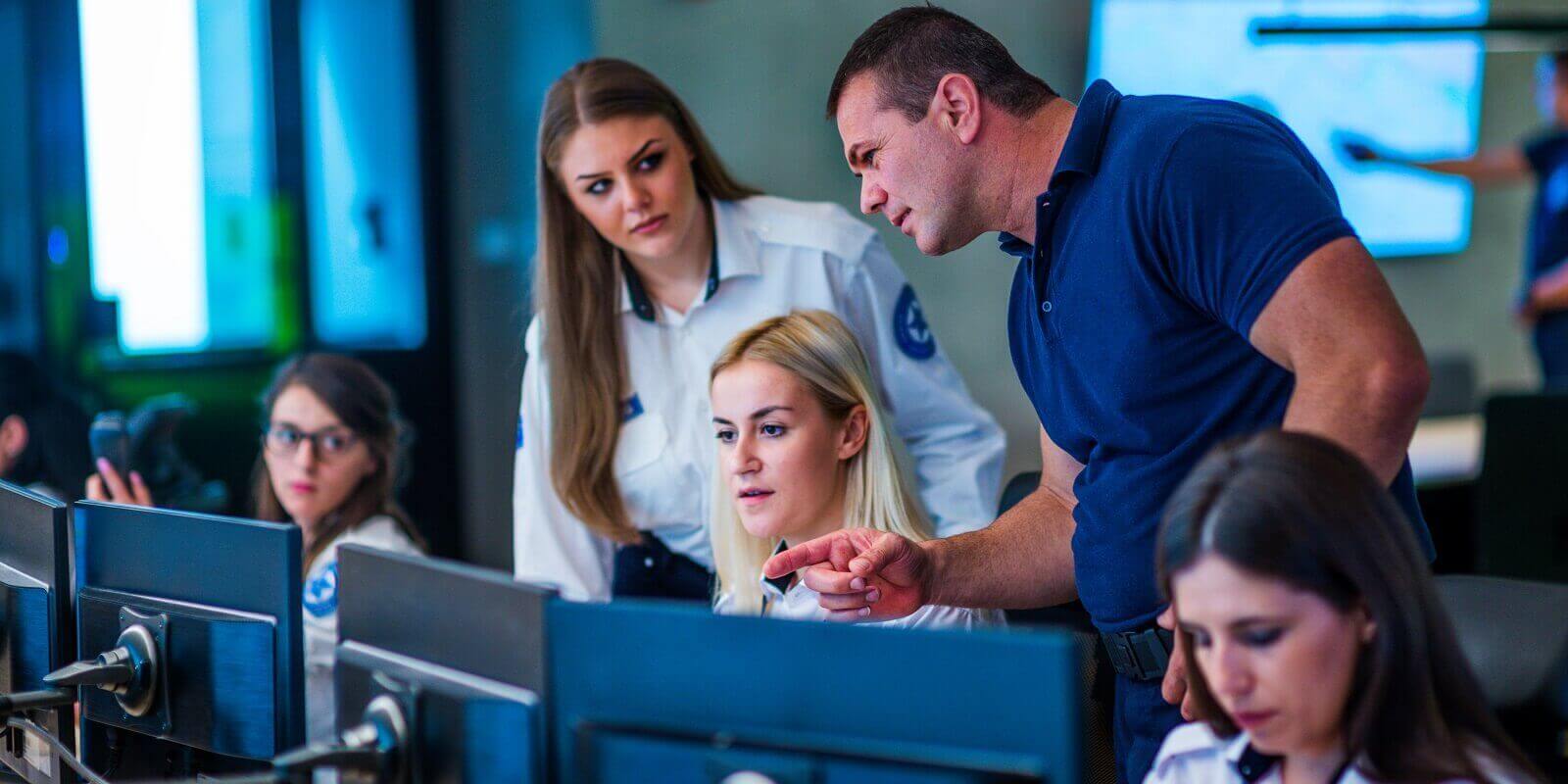 security guards working in surveillance room