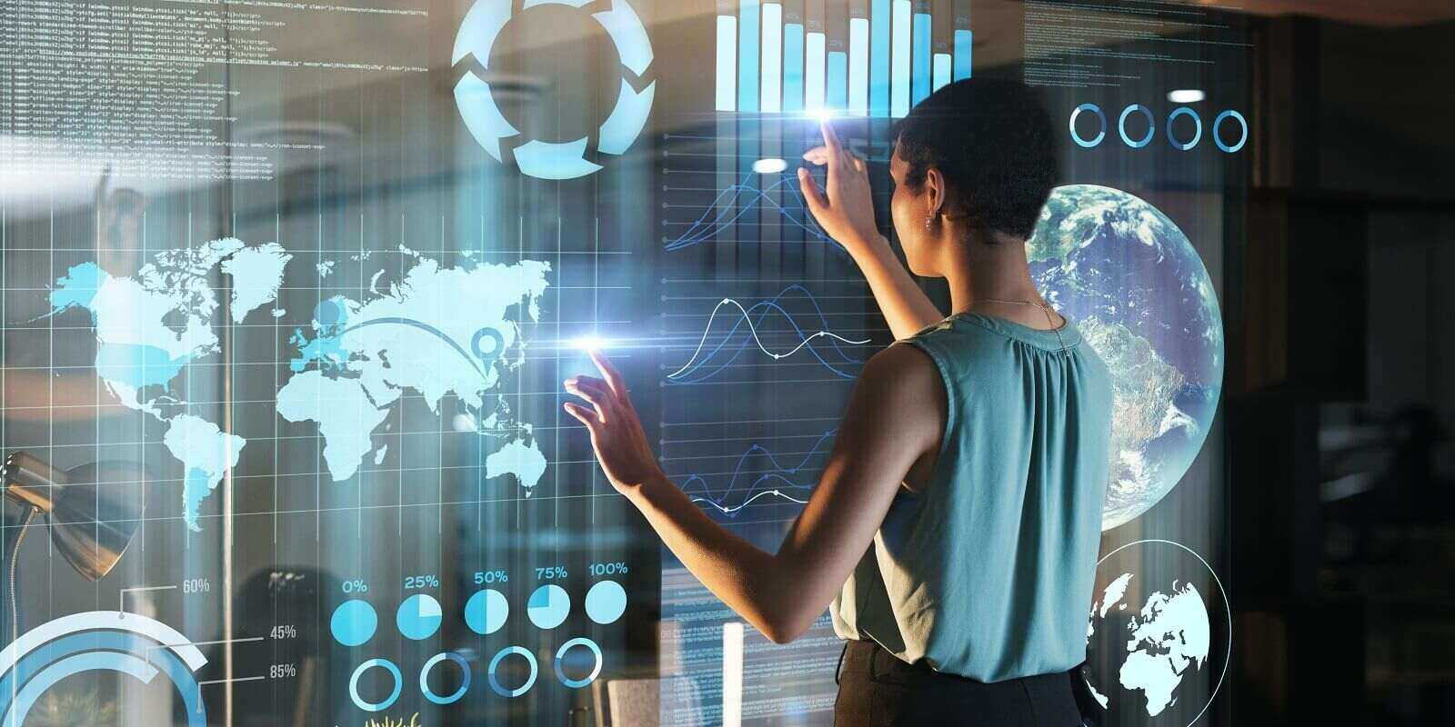 future hologram and woman pointing at finance dashboard
