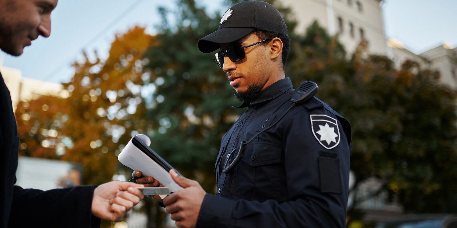 police checking the driver's license from driver