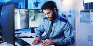 computer screen and security with man in office at night for monitoring, protection or safety