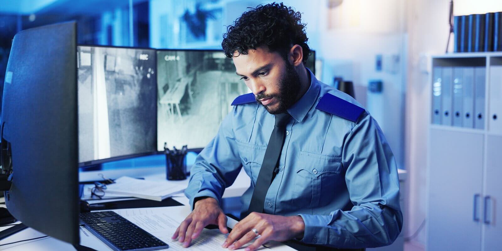 computer screen and security with man in office at night for monitoring, protection or safety