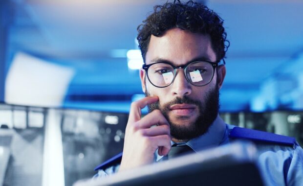 tablet and thinking with man in office at night for monitoring