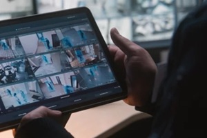 male security officer controls CCTV cameras in office