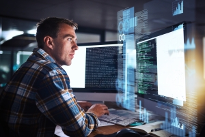 Developer, man and programmer code on computer screen with cybersecurity hologram, analytics and seo or working at night. Technology, coding and hacker on dark software, safety and iot password.