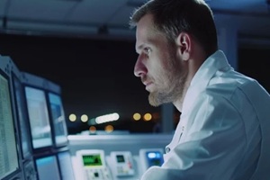 security officer, operating a computer in the security control center room