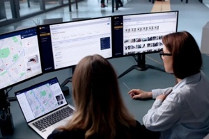 woman studies crime maps on laptop using geospatial software