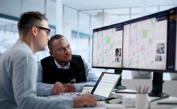crime analyst studies crime patterns on laptop